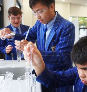 St Thomas of Canterbury College boys performing scientific experiment