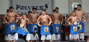 St Thomas of Canterbury College boys on stage wearing traditional dress for pollyfest
